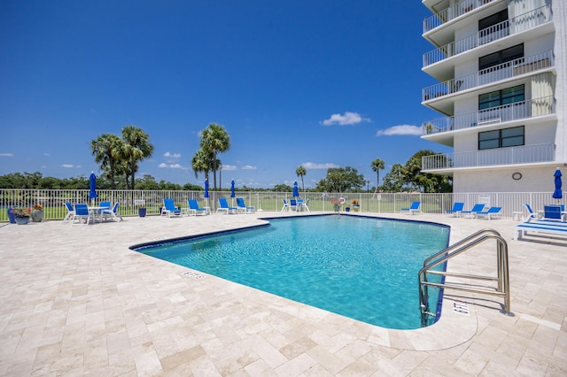 336 Golfview Rd Unit 1011, North Palm Beach, FL 33408 - community pool with a patio and fence