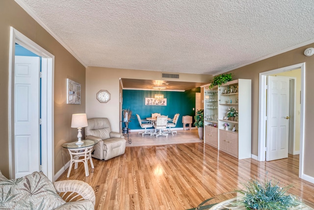 living room with a textured ceiling and light wood-type flooring