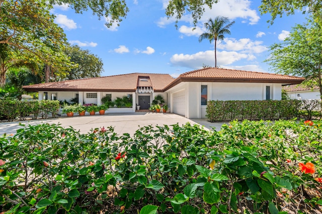 mediterranean / spanish-style home with a garage