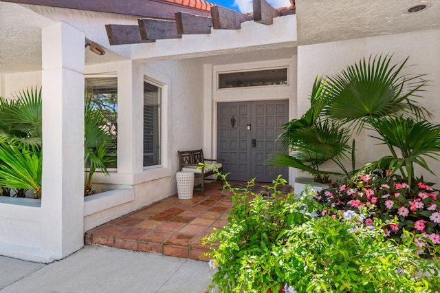 property entrance featuring a pergola