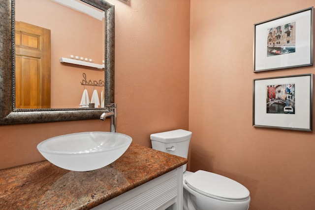 bathroom featuring toilet and vanity