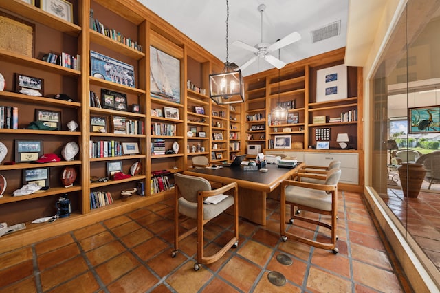 interior space with ceiling fan, dark tile flooring, and built in shelves