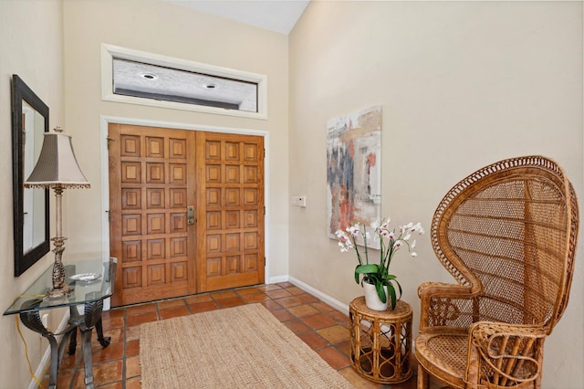 foyer entrance featuring dark tile flooring