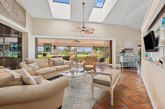 living room featuring ceiling fan, a skylight, and tile flooring