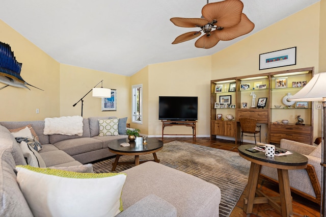 living room featuring ceiling fan and vaulted ceiling