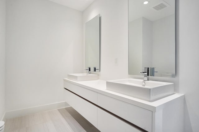 bathroom featuring hardwood / wood-style flooring and vanity