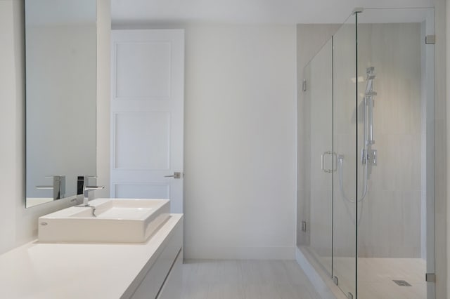 bathroom featuring vanity and an enclosed shower