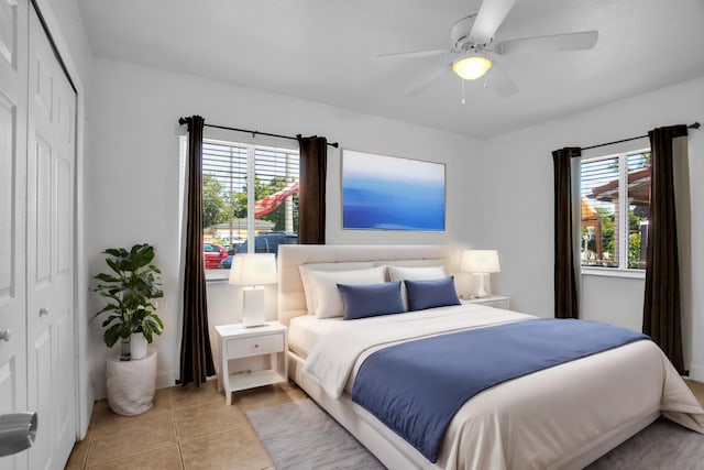 bedroom with a closet, ceiling fan, and multiple windows