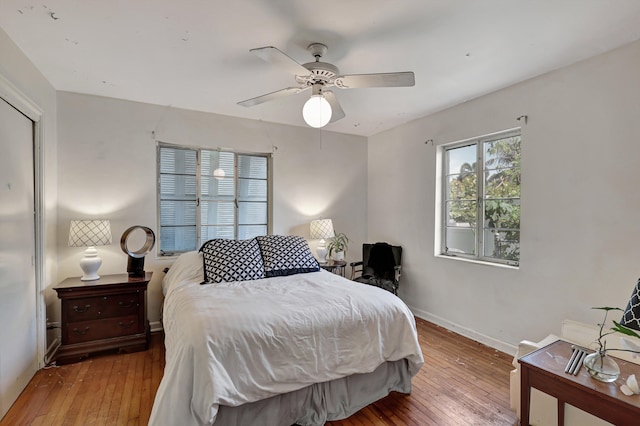 bedroom with wood-type flooring and ceiling fan