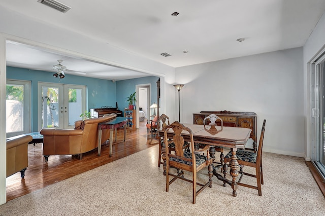 dining space with french doors, light hardwood / wood-style floors, and ceiling fan