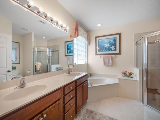 full bathroom featuring independent shower and bath, double sink, large vanity, and tile flooring