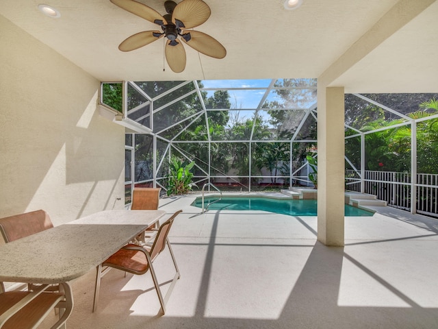 view of swimming pool featuring a patio area, ceiling fan, and a lanai