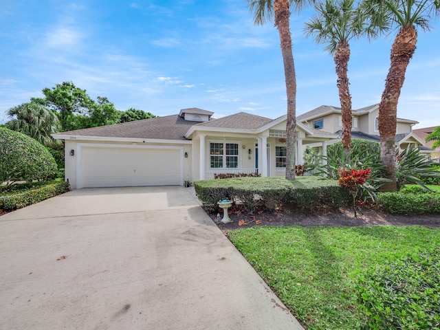 view of front of home featuring a front yard and a garage