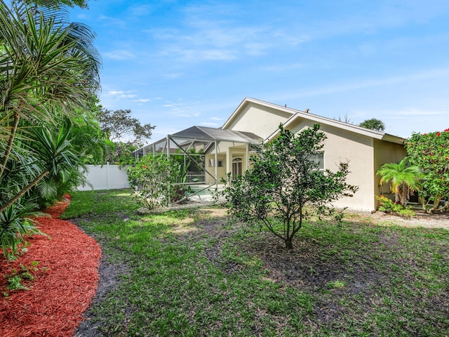 view of front of property with a front yard and a lanai