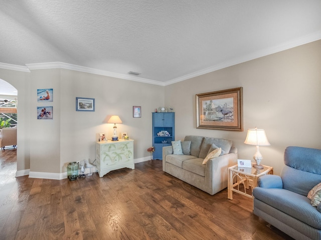 living room featuring a textured ceiling, ornamental molding, and dark hardwood / wood-style floors