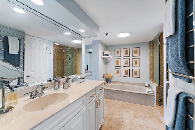 bathroom featuring vanity and shower with separate bathtub