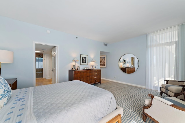 carpeted bedroom with multiple windows