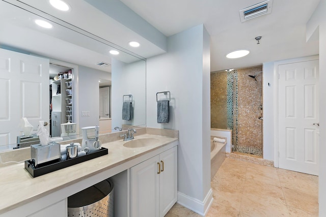 bathroom featuring vanity, independent shower and bath, and tile patterned flooring