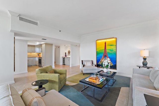 living room with crown molding, wine cooler, and light tile patterned floors