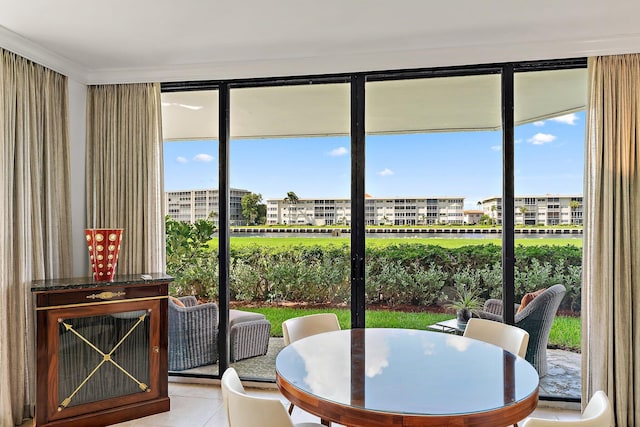 dining space with light tile patterned floors and a wall of windows