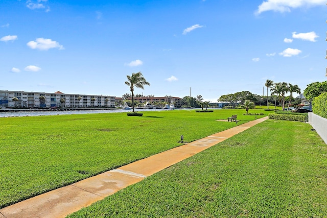 surrounding community featuring a water view and a yard