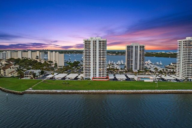 aerial view at dusk featuring a water view