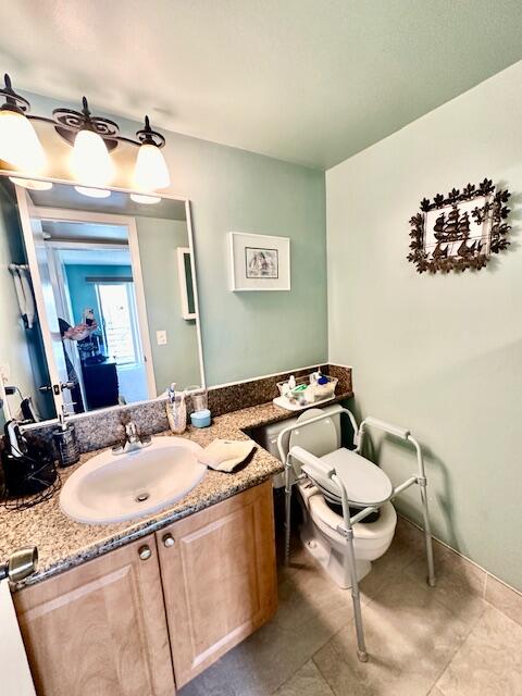 bathroom with tile floors and vanity