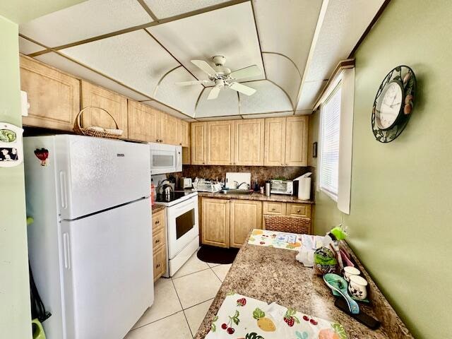 kitchen featuring white appliances, ceiling fan, light tile floors, tasteful backsplash, and light brown cabinets