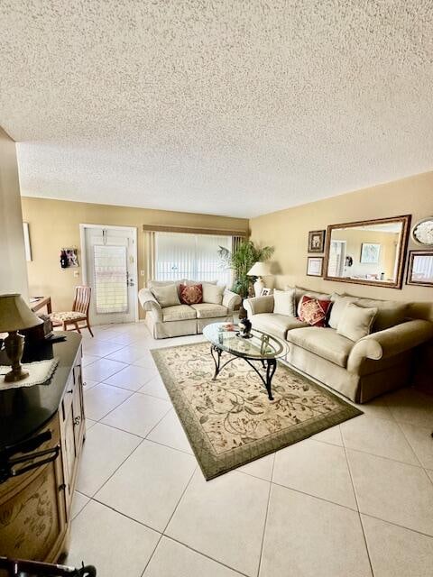 living room featuring light tile floors and a textured ceiling