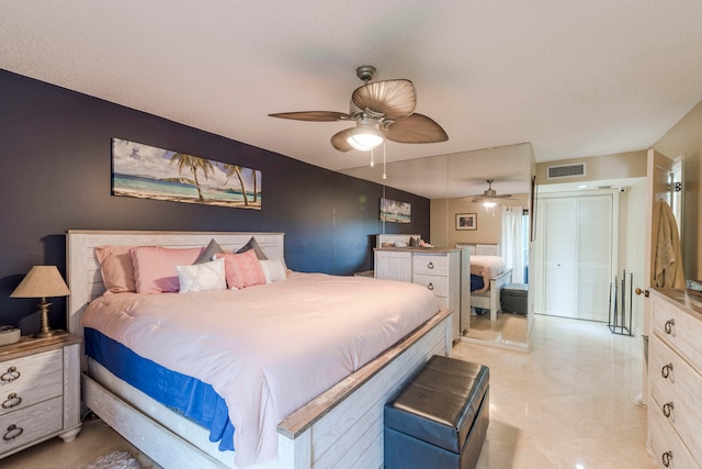 bedroom featuring light tile floors and ceiling fan