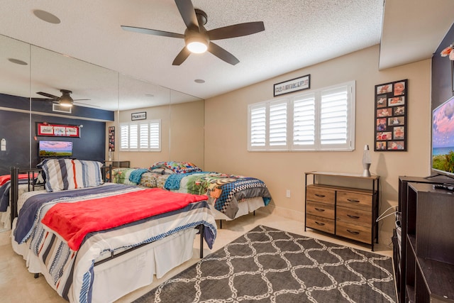 carpeted bedroom featuring ceiling fan, multiple windows, and a textured ceiling