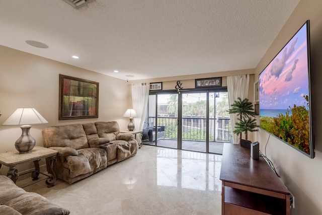 tiled living room featuring a textured ceiling