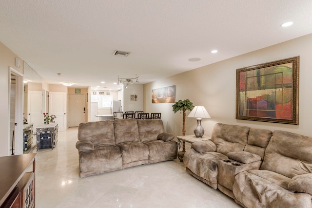 living room with track lighting and a textured ceiling