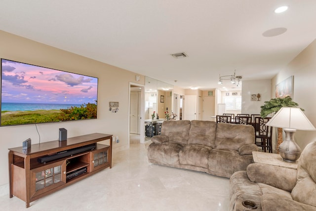 living room featuring a water view and light tile floors