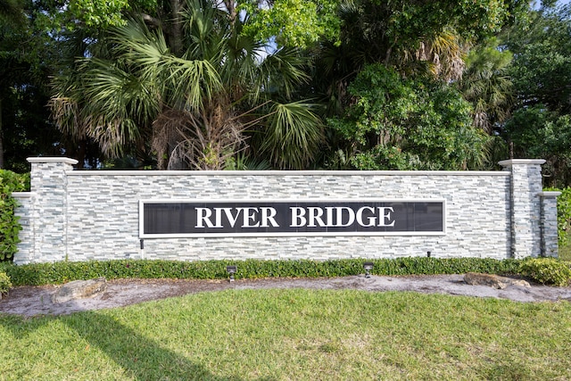 community / neighborhood sign featuring a lawn