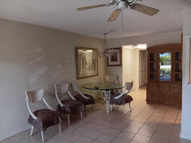 living area with light tile floors, a textured ceiling, and ceiling fan with notable chandelier