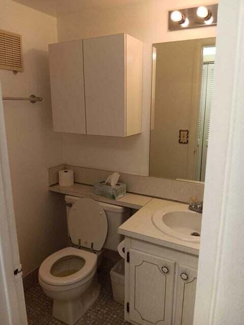 bathroom with toilet, tile floors, and large vanity