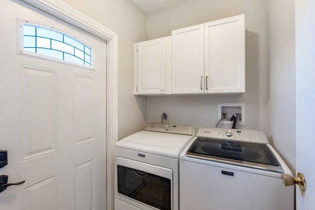 laundry room featuring washer hookup, cabinets, electric dryer hookup, and washing machine and dryer