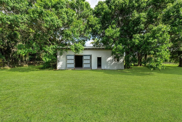 back of property featuring a lawn