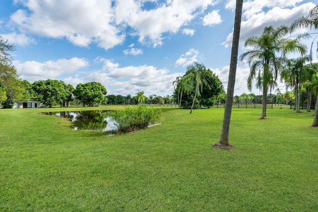 exterior space with a water view and a lawn