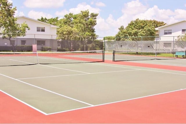 view of tennis court with basketball hoop