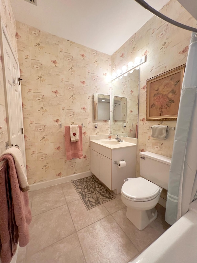 full bathroom with shower / tub combo, vanity, tile flooring, and toilet