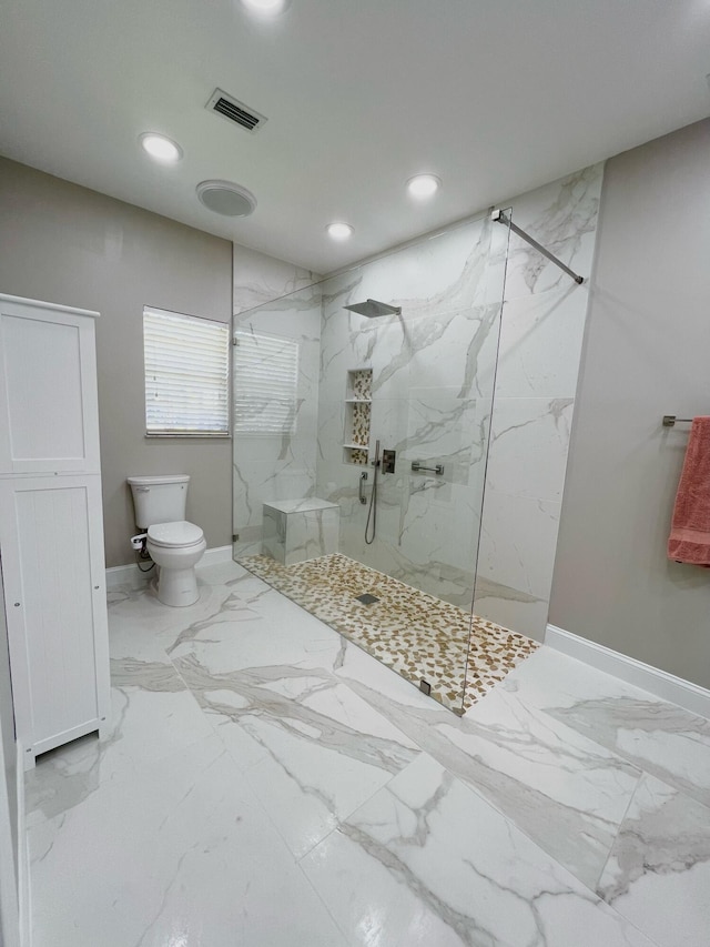 bathroom featuring toilet, tile floors, and a tile shower