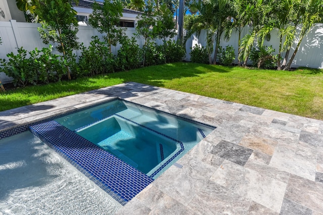 view of pool with a yard, an in ground hot tub, and a patio