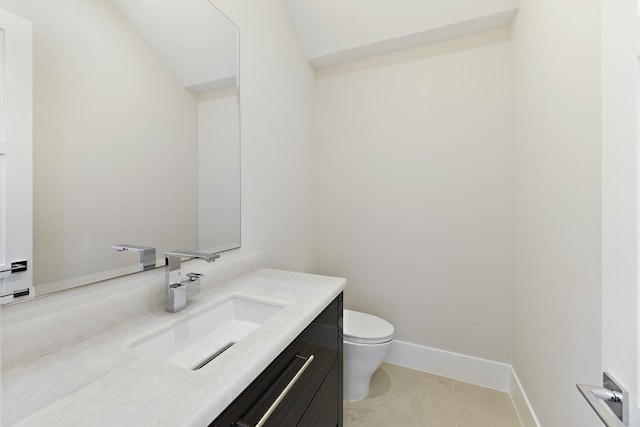 bathroom with vanity, tile floors, and toilet