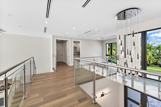 hallway with light hardwood / wood-style floors