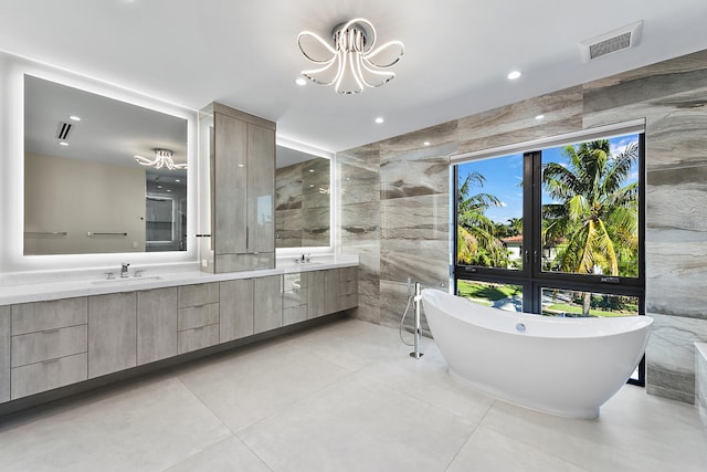 bathroom featuring tile floors, a healthy amount of sunlight, and a chandelier