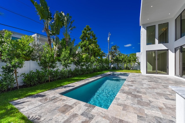 view of swimming pool featuring a patio area