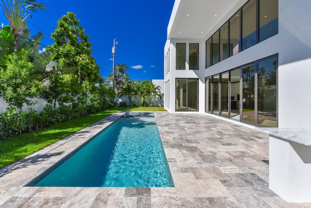 view of pool featuring a patio area and a yard