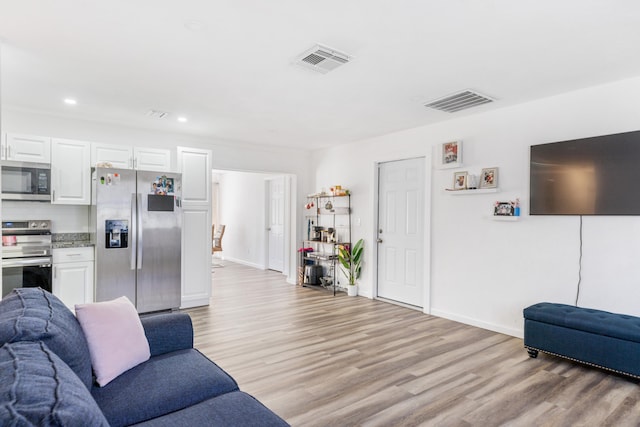 living room with light hardwood / wood-style flooring